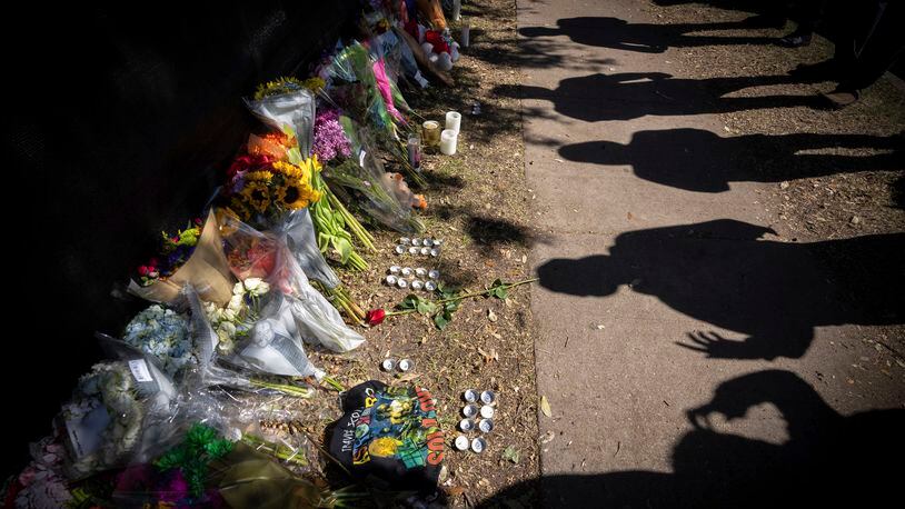 FILE - Visitors cast shadows at a memorial to the victims of the Astroworld concert in Houston on Nov. 7, 2021. Nine of the 10 wrongful death lawsuits filed after deadly crowd surge at the 2021 Astroworld festival have been settled, including one that was set to go to trial this week, an attorney said Wednesday, May 8, 2024. (AP Photo/Robert Bumsted, File)