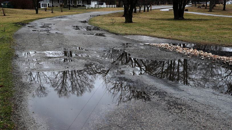 New Carlisle has about $800,000 saved up after being nearly broke about five years ago. They plan to resurface the road into Smith Park. BILL LACKEY/STAFF