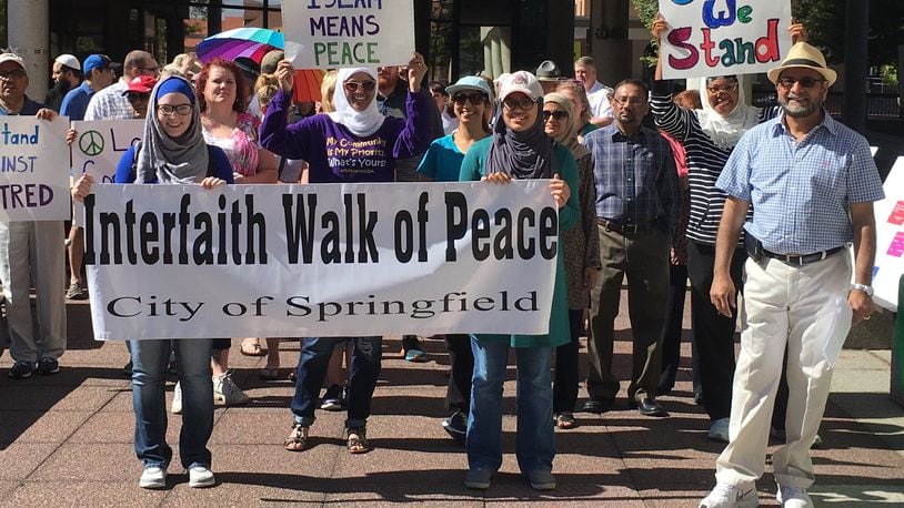 Members of the Miami Valley Islamic Association of Springfield participate in a peace walk in downtown Springfield.