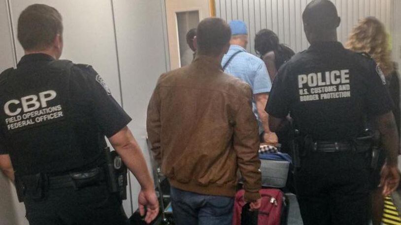 Atlanta U.S. Customs and Border Protection agents escort Gentian Kurdina, 23, after the Albanian national deserted his cruise ship in Louisiana and boarded a train bound for New York City.