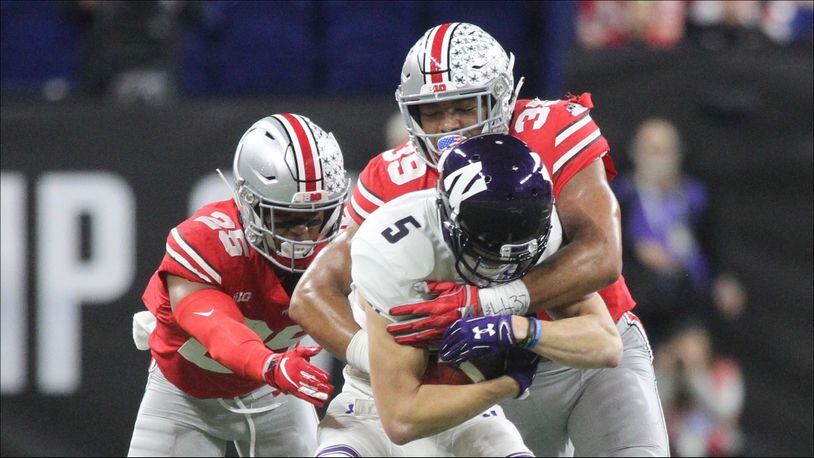 Ohio StateÃ­s Malik Harrison (39) and Brendon White (25) tackle NorthwesternÃ­s Isaiah Bowser, a Sidney High School graduate, in the Big Ten Championship on Saturday, Dec. 1, 2018, at Lucas Oil Stadium in Indianapolis. David Jablonski/Staff