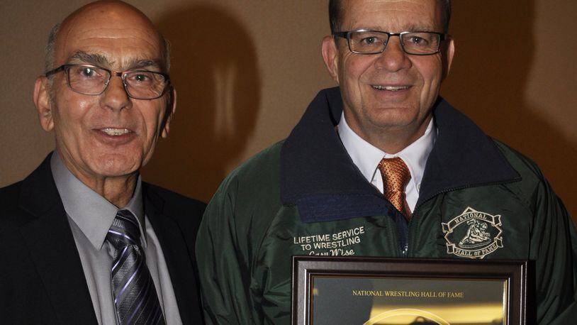 Stamat Bulugaris (left), now a Beavercreek middle school wrestling coach, and Beavercreek coach Gary Wise during Wise’s induction into the National Wrestling Hall of Fame Ohio Chapter at Columbus this fall. CONTRIBUTED PHOTO