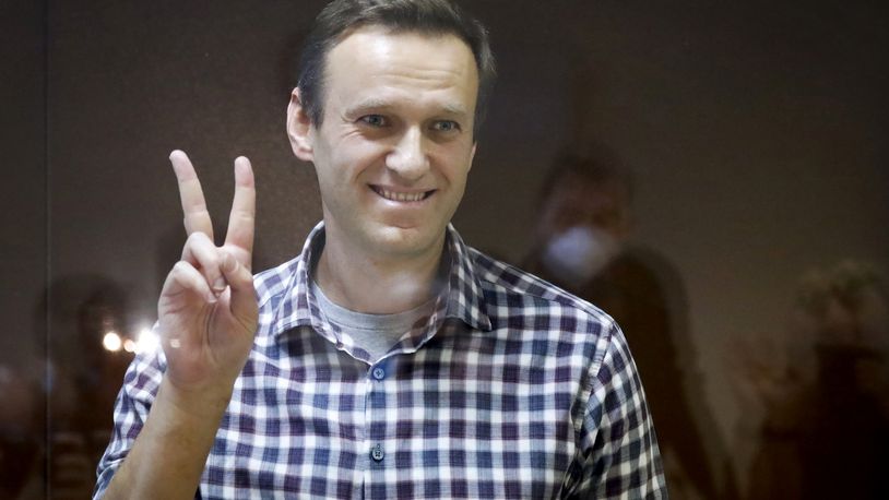 FILE - Russian opposition leader Alexei Navalny gestures as he stands in a cage in the Babuskinsky District Court in Moscow, Russia, Saturday, Feb. 20, 2021. A memoir Alexei Navalny began working on in 2020 will be published this fall. "Patriot," which publisher Alfred A. Knopf is calling the late Russian opposition leader's "final letter to the world," will come out Oct. 22. (AP Photo/Alexander Zemlianichenko, File)