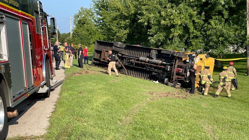 A Northwestern local schools bus with elementary schoolers inside flipped over in an accident involving another vehicle in the 4100 block of Troy Road (Ohio 41) at Lawrenceville near the German Twp. fire station on Tuesday, Aug. 22, 2023. BILL LACKEY/STAFF