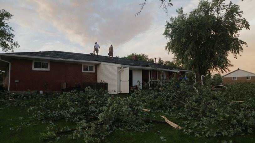 A homeowner repairs his roof along Delrey Road Wednesday evening, June 8, 2022, in German Twp. after it was damaged in the storms. An EF1 tornado touched down north of Springfield. BILL LACKEY/STAFF