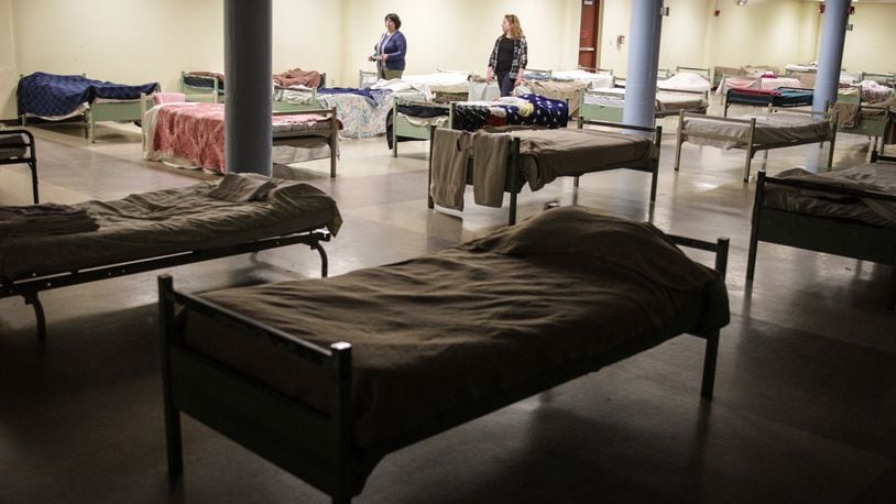 The beds at St. Vincent de Paul homeless shelter on Apple Street in Dayton had to be moved farther apart because of the coronavirus. Almost 100 people had to be moved into local hotels because of coronavirus overcrowding. JIM NOELKER/STAFF