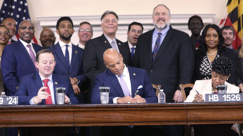 Maryland Gov. Wes Moore signs legislation on Tuesday, April 9, 2024 in Annapolis, Md., to help employees of the Port of Baltimore affected by the Francis Scott Key Bridge collapse. It authorizes use of the state's rainy day fund to provide financial help. (AP Photo/Brian Witte)