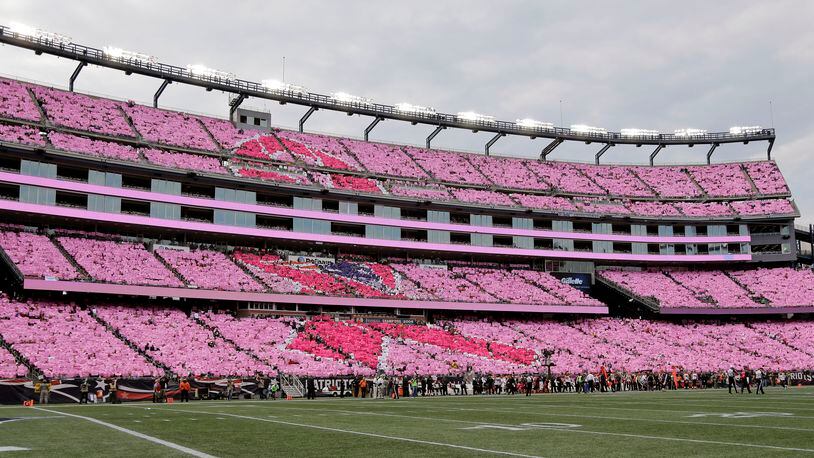 Fans in the stands at Gillette Stadium perform a card stunt with pink cards to mark breast cancer awareness month during the first half of an NFL football game Oct. 16, 2016, in Foxborough, Mass.