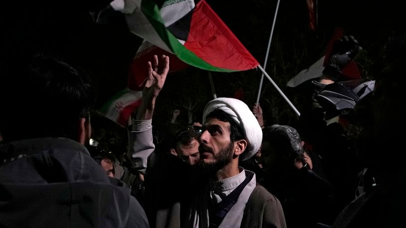 A cleric chants slogans during an anti-Israeli gathering in front of the British Embassy in Tehran, Iran, early Sunday, April 14, 2024. Iran launched its first direct military attack against Israel on Saturday. (AP Photo/Vahid Salemi)