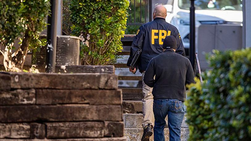 In this Wednesday, Dec. 18, 2019 photo, FBI agents canvas the neighborhood searching for information on Heidi Broussard, a missing Austin, Texas, woman and her infant daughter in South Austin, Texas. (Ricardo B. Brazziell/Austin American-Statesman via AP)