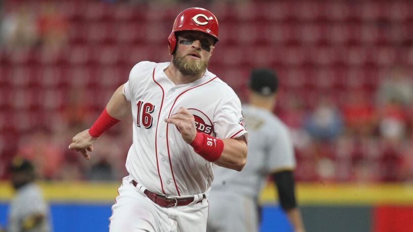 The Reds’ Tucker Barnhart rounds third base and scores in the first inning against the Pirates on Tuesday, May 22, 2018, at Great American Ball Park in Cincinnati. David Jablonski/Staff