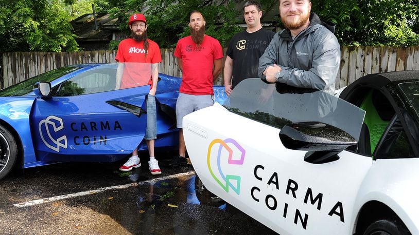 The creators of Carma Coin, in Yellow Springs, from left, Brad Butcher, Cecil Mark, Scott Morin and David Butcher. MARSHALL GORBY\STAFF
