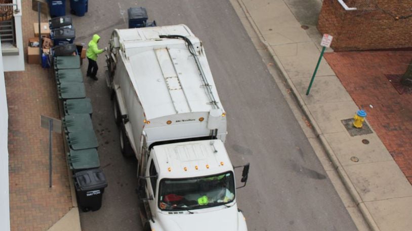 Rumpke crews pick up recycling in downtown Dayton. CORNELIUS FROLIK / STAFF