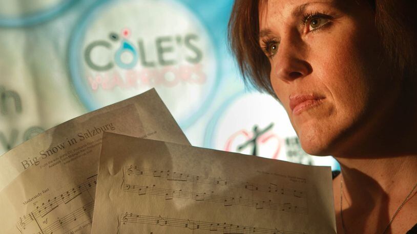 Danielle Smoot is the founder of Cole’s Warriors, a coalition she started through Family and Youth Initiatives in response to the prescription pill overdose death of her 16-year-old son Cole. She holds a special keepsakes of Cole’s: sheet music of the song Big Snow in Salzburg that he learned to play on the piano right before his death. JIM WITMER / STAFF