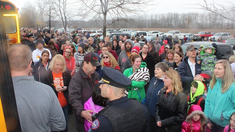 Parents wait for their children to get of buses at Lions Park in West Liberty after a shooting at West Liberty-Salem High School in January. JEFF GUERINI/STAFF