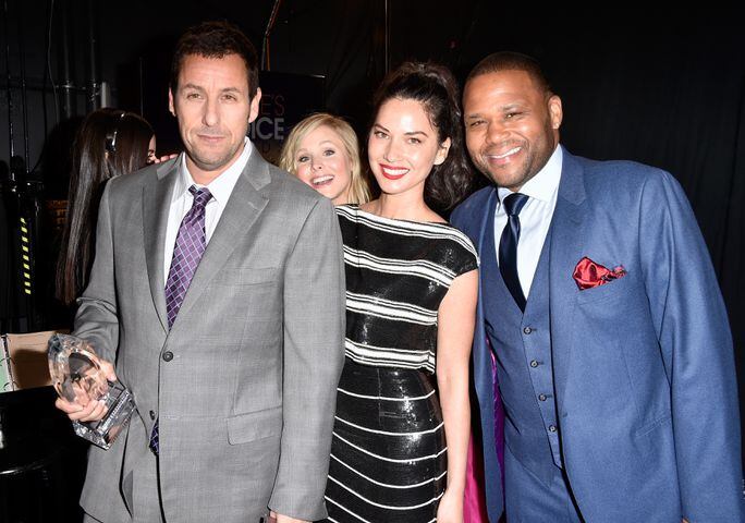 Actress Kristen Bell (2nd from L) photobombs (L-R) actor Adam Sandler, actress Olivia Munn and actor Anthony Anderson