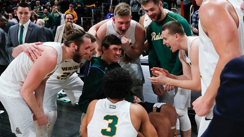 Wright State playerscelebrate their 74-57 win against Cleveland State with Ryan Custer after an NCAA basketball game in the Horizon League tournament championship in Detroit, Tuesday, March 6, 2018. (AP Photo/Paul Sancya)