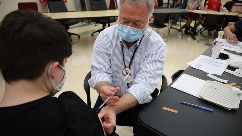 The Clark County Combined Health District has scheduled many clinics this week to help get more people vaccinated, just like this one at Tecumseh High School where Dr. John Dobson gave Carsen Williams, 13, his COVID-19 vaccination last month. BILL LACKEY / STAFF
