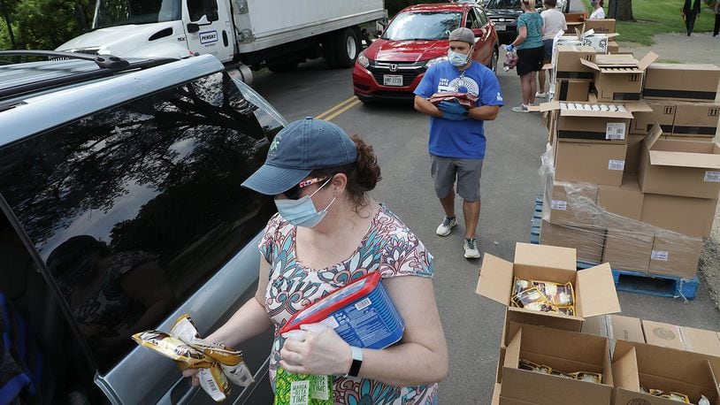 Volunteers from the Springfield Arts Council distributed food for the Second Harvest Food Bank Wednesday in Veteran’s Park. BILL LACKEY/STAFF