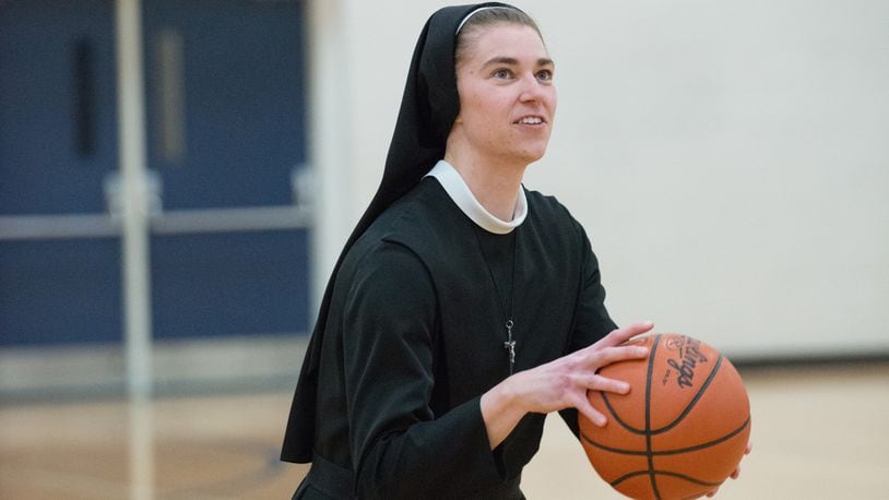 Sister Mary Xavier, showing her old Ohio State and Anna High form, getting ready to launch a shot when she spoke to a group of over 700 people at the Russia High gym in the summer of 2018. Before the convent, when she was Sarah Schulze, she scored 1,569 points and grabbed 880 rebounds in her Anna High career and then played 111 games for the Buckeyes and was the team captain as a senior. Photo courtesy of Nicole Voisard/Simply Nicole Photography