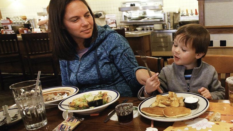 Tanya Thompson of Denver, Colo., eats with her son Ben, 3, at the Bob Evans restaurant on Dorothy Lane in Kettering in this file photo. Bob Evans will be among the eateries and retailers opting to be open for business on Thanksgiving Day. CHRIS STEWART / STAFF