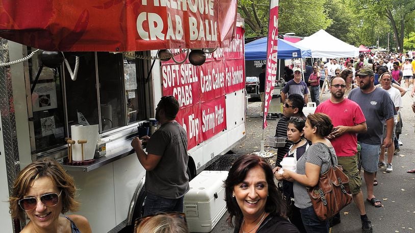 People wait in line to sample some of the Firehouse Crab Balls at the 2016 Springfield Rotary Gourmet Food Truck Competition in Veterans Park. Bill Lackey/Staff