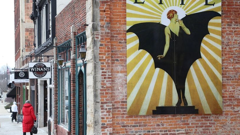 A mural image of a ”bat girl” created by a Springfield native C. Coles Phillips for LIFE Magazine in the 1920s, graces the side of the Pappas Building on Fountain Ave., the first of a series of murals that will become part of a larger project to beautify the city with more public art. BILL LACKEY/STAFF