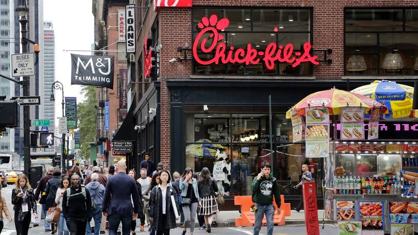 People walk past a new Chick-fil-A restaurant, Thursday, Oct. 1, 2015 in New York. The Atlanta-based privately held franchise company has more than 1900 restaurants in 41 states and Washington, D.C. The New York franchise, located a few blocks from Times Square, opens Saturday, Oct. 3, marking its push to become a bigger national player. (AP Photo/Mark Lennihan)