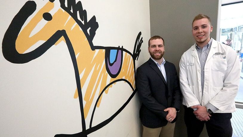 Andrew Straw, Assistant Professor of Pharmacy Practice at Cedarville University and Residency Program Director, and Josh Willoughby, Pharmacy Resident from Cedarville at the Rocking Horse Center. Bill Lackey/Staff