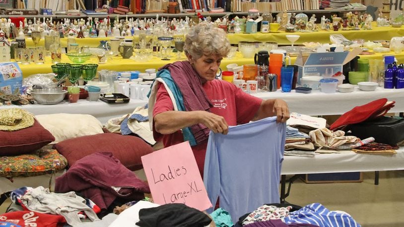 Denise Skaggs folds clothing at the Special Olympics Garage Sale at the FF Mueller campus, 2535 Kenton Street. The salek, which runs through Saturday, helps pay for Special Olympians in Clark County to go to the Special Olympics in Columbus. BILL LACKEY/STAFF