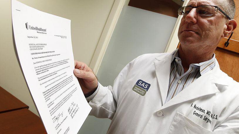 Dr. Rick Nedelman, a doctor at the SAS Surgery and Vein Specialists in Springfield, looks over a letter he received from UnitedHealthcare insurance letting him know that he is one of many local doctors being dropped from the company’s Medicare coverage group. Bill Lackey/Staff
