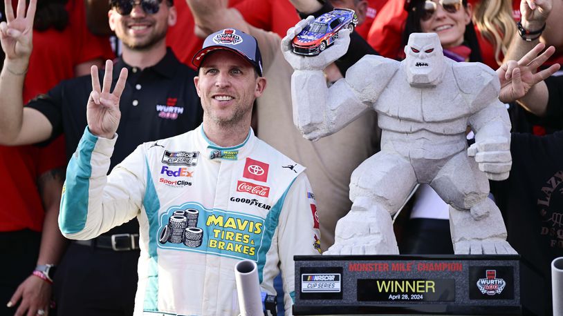 Denny Hamlin, front left, celebrates in Victory Lane after winning a NASCAR Cup Series auto race at Dover Motor Speedway, Sunday, April 28, 2024, in Dover, Del. (AP Photo/Derik Hamilton)