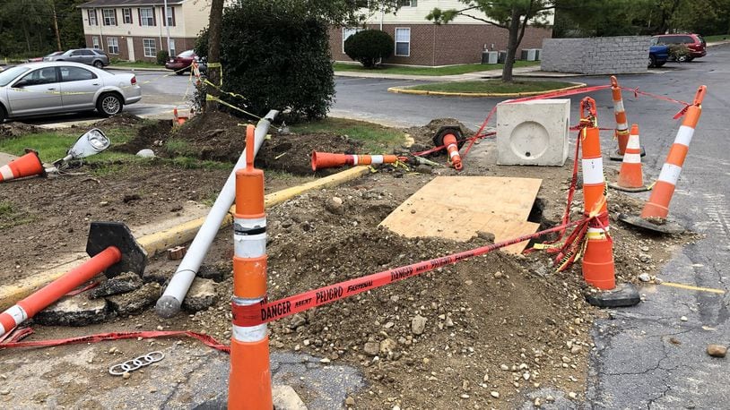 The utility pole and construction hole that the driver fell in while fleeing the scene in Ronez Apartments. BILL LACKEY/STAFF