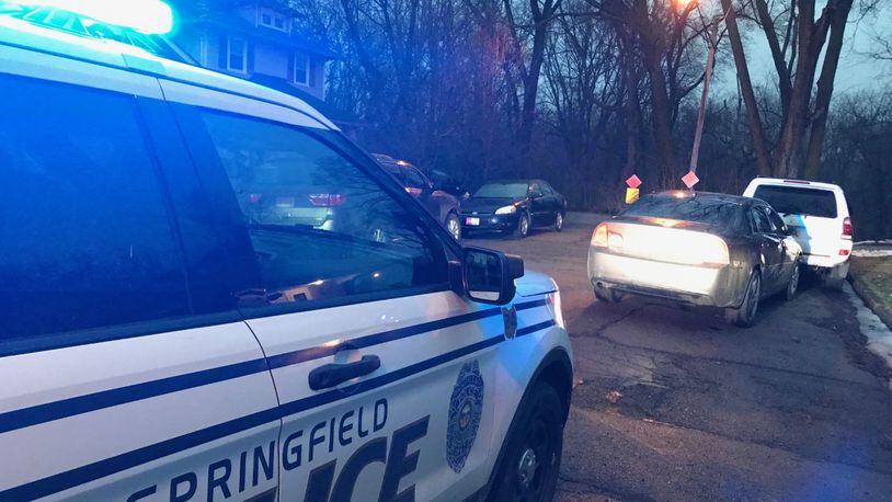 Springfield Police are looking for a suspect who escaped into the woods on Cecil Street on Tuesday evening after a pursuit involving a U.S. Marshall. Another suspect was taken into custody a short distance away. ERIC HIGGENBOTHAM/STAFF