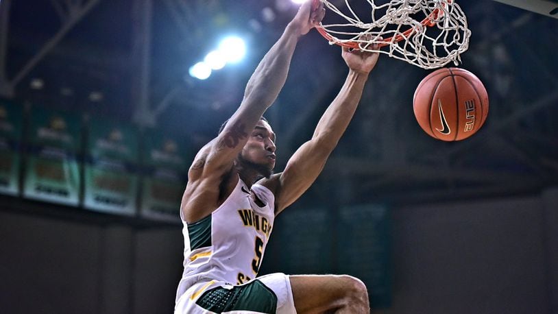 Wright State’s Skyelar Potter dunks home two of his team-high 17 points during Thursday’s win over Northwestern Ohio at the Nutter Center. Joseph Craven/CONTRIBUTED