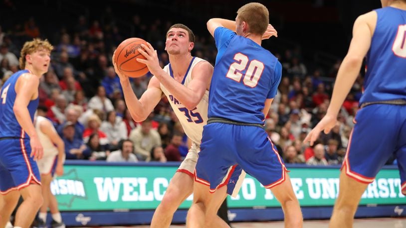 Tri-Village High School senior Justin Finkbine prepares to shoot the ball over Greeneview senior Ben Myers during their Division III district final game on Friday night at UD Arena. The Patriots won 60-50. CONTRIBUTED PHOTO BY MICHAEL COOPER