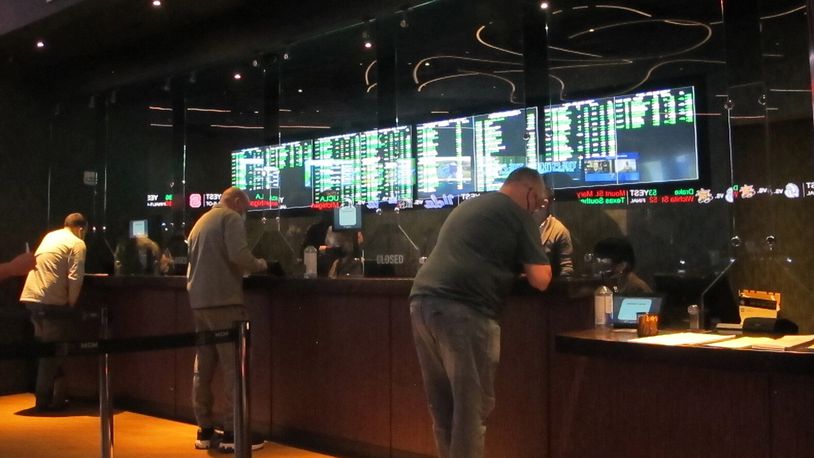 FILE - People line up to make sports bets at the Borgata casino in Atlantic City, N.J., March 19, 2021. Sports betting becomes legal in the state of Ohio on Jan. 1. (AP Photo/Wayne Parry, File)