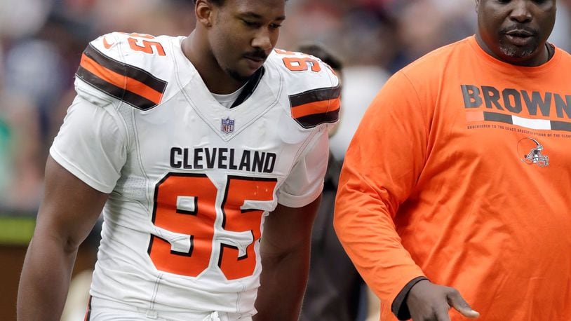 FILE - In this Oct. 15, 2017, file photo, Cleveland Browns defensive end Myles Garrett (95) walks off the field at the half during an NFL football game against the Houston Texans in Houston. Garrett has been placed in concussion protocol. The top pick in this year’s NFL draft reported to the team’s facility on Wednesday with concussion-like symptoms. It’s unlikely he’ll play in Sunday’s game at London. Garrett has four sacks in three games. He missed the season’s first four games with a sprained ankle. (AP Photo/Eric Gay, File)