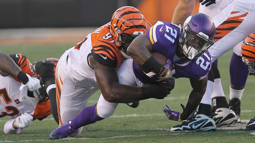 CINCINNATI, OH - AUGUST 12: Jerick McKinnon #21 of the Minnesota Vikings runs the football upfield against Marcus Hardison #21 of the Cincinnati Bengals during their game at Paul Brown Stadium on August 12, 2016 in Cincinnati, Ohio. The Vikings defeated the Bengals 17-16. (Photo by John Grieshop/Getty Images)