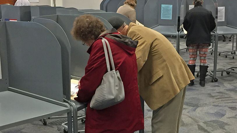 Voters cast their ballots at an Urbana poll Tuesday. BILL LACKEY/STAFF