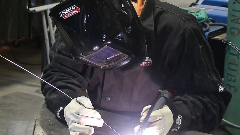 Clark State Community College welding instructor, Jonathan Pack demonstrates a welding process. JEFF GUERINI/STAFF