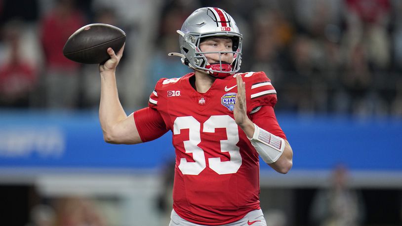 Ohio State quarterback Devin Brown throws a pass against Missouri during the first half of the Cotton Bowl NCAA college football game Friday, Dec. 29, 2023, in Arlington, Texas. (AP Photo/Julio Cortez)