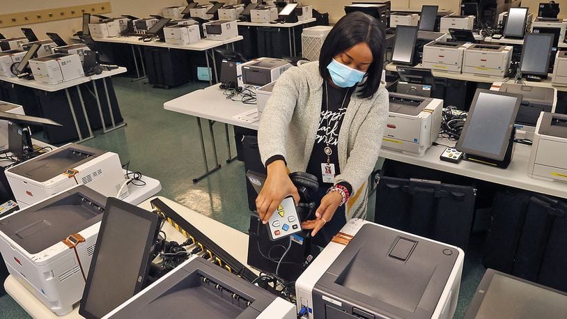 Camille Hall, from the Clark County Board of Elections, sets up accessible voting equipment for disabled voters for testing next week at the Board of Elections Friday, March 25, 2022. BILL LACKEY/STAFF