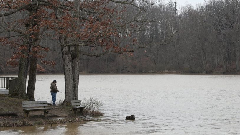 A fisherman tries his luck in Hosterman Lake at George Rogers Clark Park Friday. BILL LACKEY/STAFF