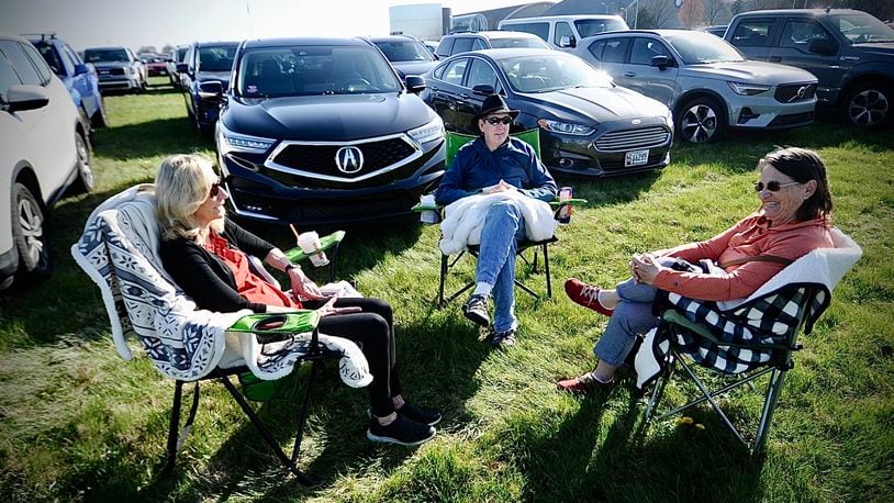Visiting the National Museum of the United States Air Force to watch the eclipse on Monday, April 8, 2024, from left, Barb Shank of West Chester Twp. and relatives Nick and Patti Kirch from Washington state. MARSHALL GORBY \STAFF