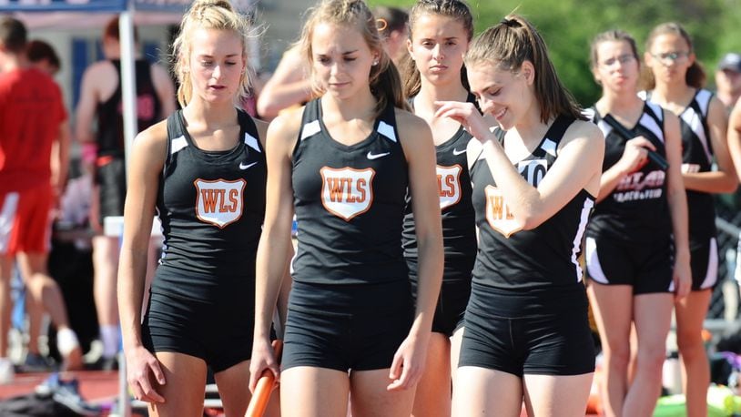 West Liberty-Salem’s 3,200-meter relay team of (from left) Grace Adams, Megan Adams, Madison Bahan and Katelyn Stapleton set a school record while winning the event at the Division III district meet Tuesday. Greg Billing / Contributed