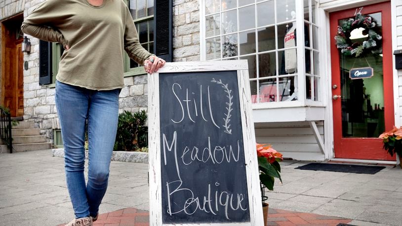 FILE - Lacey Larrick poses outside the Still Meadow Boutique, Dec. 17, 2021, in Winchester, Va. Larrick's business started in 2019 with a website and a few social media channels selling women's clothing. Record numbers of people are starting new businesses, and more and more of them are women and minorities, according to a new study. (Jeff Taylor/The Winchester Star via AP, File)