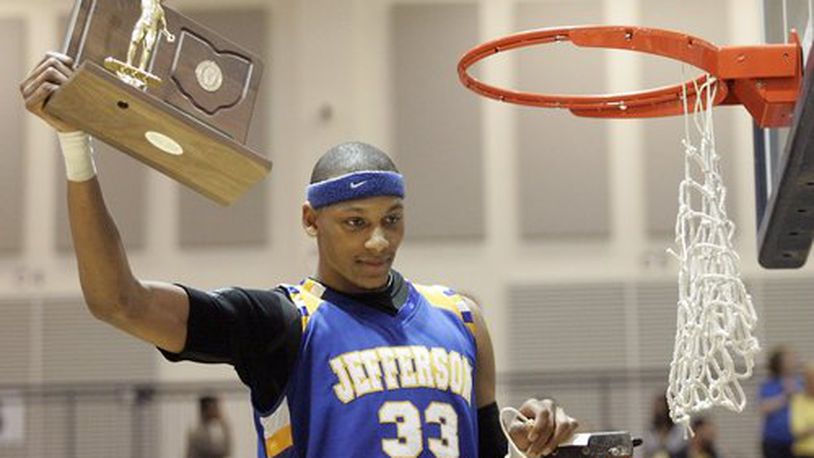 Jefferson's Adreian Payne holds the Regional championship trophy after snipping the net following the game at Trent Arena against Ft. Recovery March, 19, 2010.
