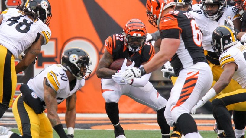 Bengals running back Jeremy Hill (32) runs up the middle during their game against the Steelers at Paul Brown Stadium, Sunday, Dec. 18, 2016. GREG LYNCH / STAFF