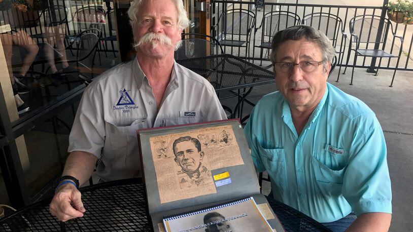 Kevin O Donnel (left) and Doug Spatz (right) with the treasured scrapbook of their great uncle Norb Sacksteder, one of the early superstars of the fledgling NFL and before that the pre-NFL pro game and the college game (including the University of Dayton). Tom Archdeacon/STAFF